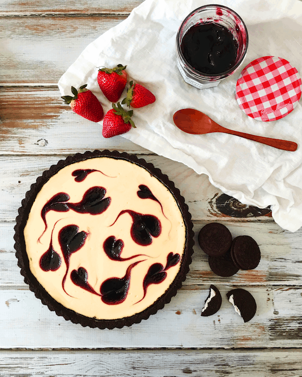 Easy, foolproof Berry Swirl Cheesecake Tart - made with a chocolate cookie crust and requires half the baking time of regular cheesecake.