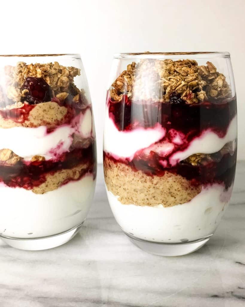 Greek Yogurt Parfaits layered with Granola, Blackberries, and Almond Butter. A healthy and flavorful breakfast or snack that can be prepared ahead and taken on-the-go.