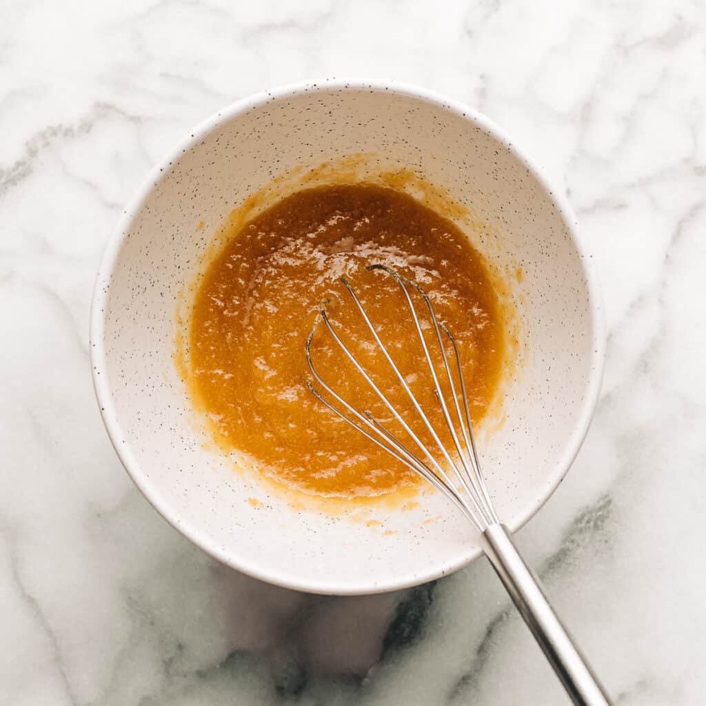 Melted butter, brown sugar, and sugar in a mixing bowl.