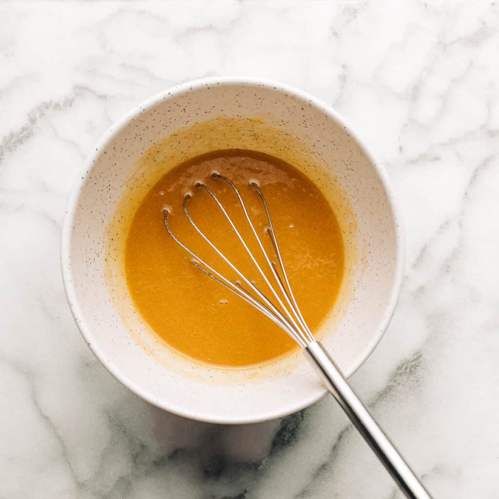 Melted butter, brown sugar, sugar, and egg in a mixing bowl.