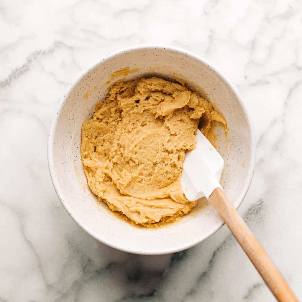 Cookie dough in a white mixing bowl.