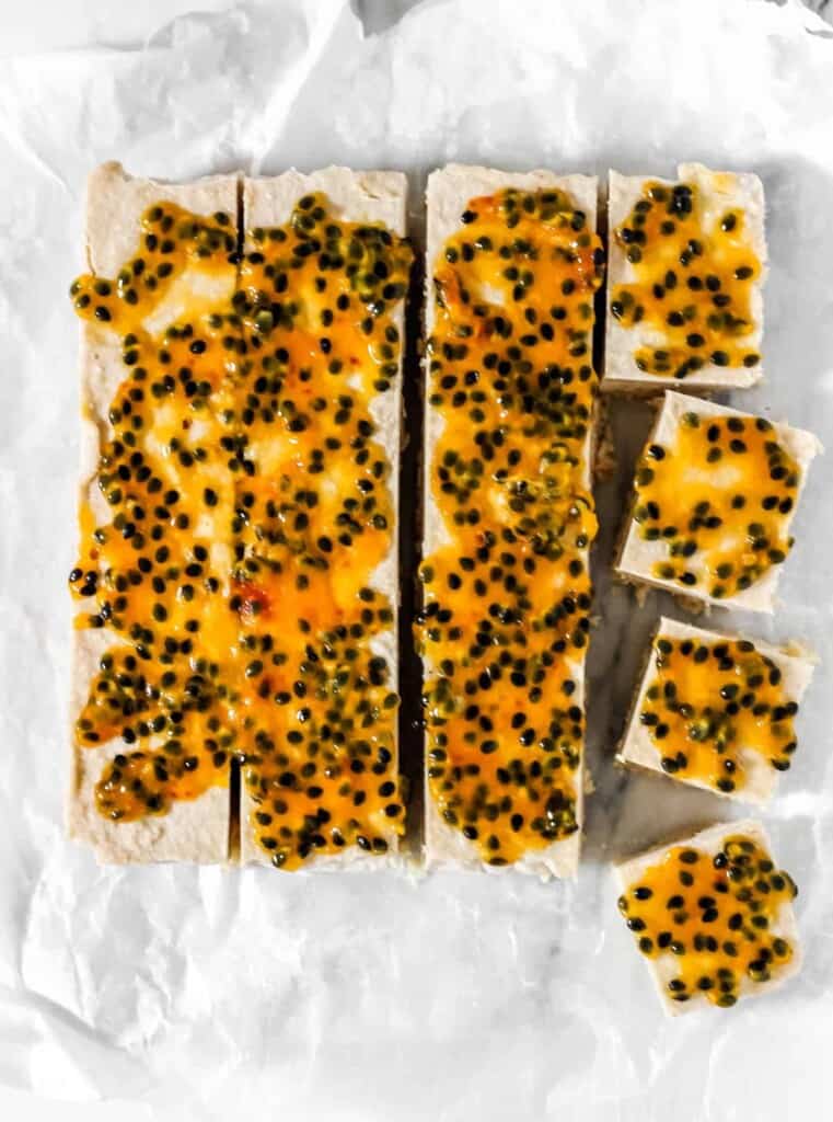 Easy to make Coconut Passionfruit Bars are so creamy and taste like you are on a tropical island. Made with simple clean ingredients plus no baking is required to make these gluten-free, Paleo, and vegan bars! 