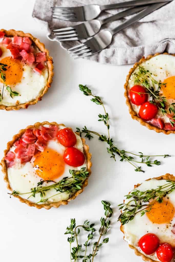 Easy Savory Breakfast Tarts made with a no-knead spelt crust and filled with goat cheese, eggs, and Canadian bacon. Perfect for breakfast or brunch, this combination is sure to satisfy appetites!