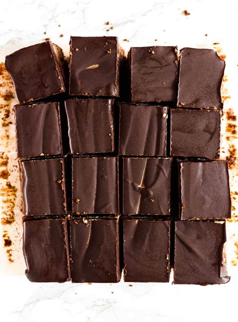 These Chocolate Coconut Caramel Bars have three addicting layers – a chocolate coconut crust, the best coconut "caramel" filling, and a dark chocolate topping! (gluten-free, Paleo + vegan)