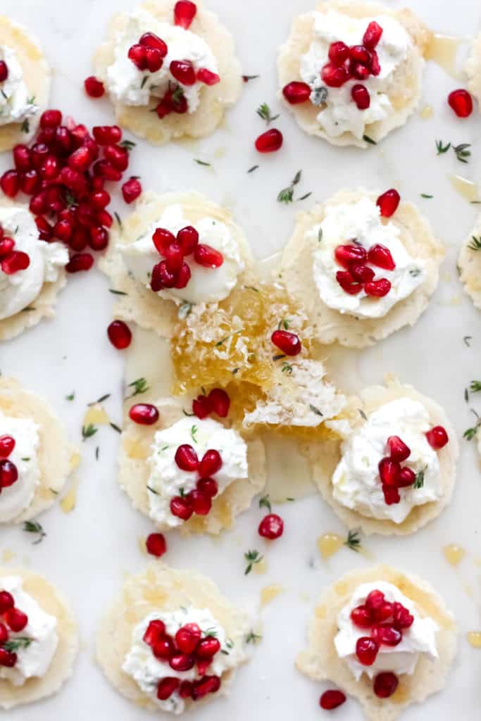 Simple, yet delicious Honey Thyme Whipped Goat Cheese Bites with Pomegranate are the perfect appetizer for the holidays!