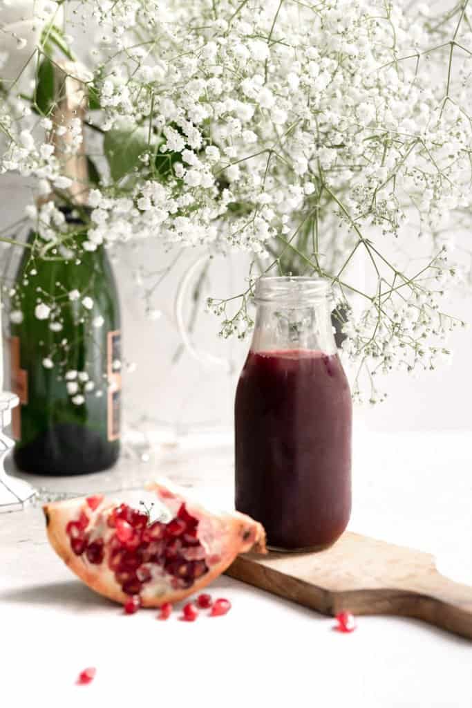 pomegranate ginger syrup in a glass jar
