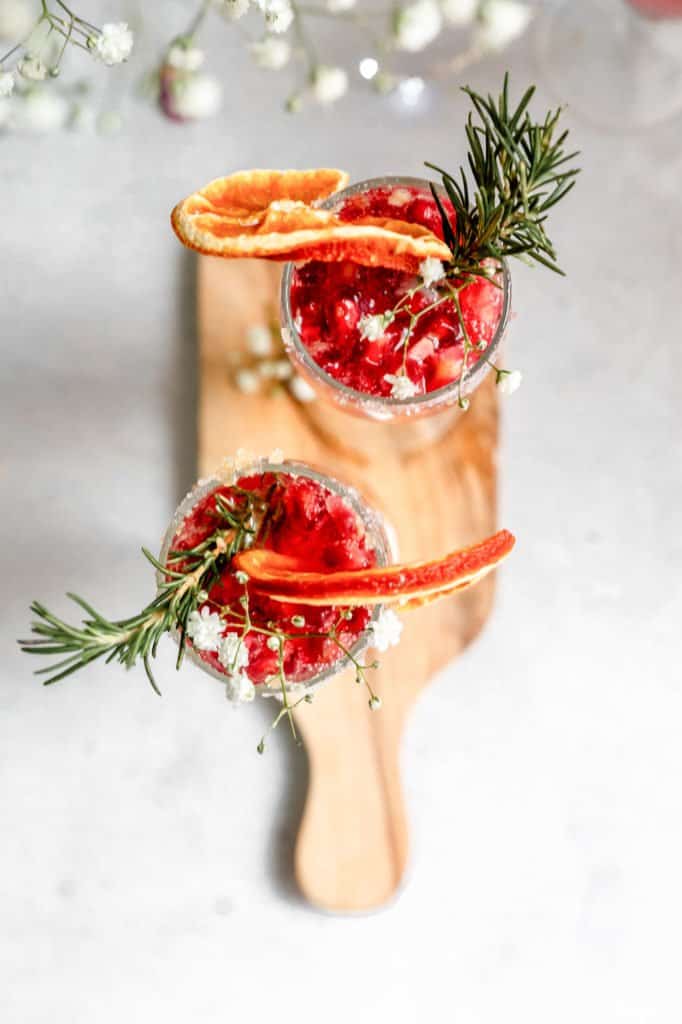 sparkling pomegranate cocktails on a wooden board