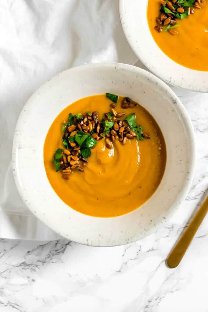 The warmth of the ginger combined with the sweetness of the sweet potato gives this Sweet Potato and Zucchini Soup with Curried Sunflower Seeds a deep, complex flavor. (vegan, GF, Paleo)