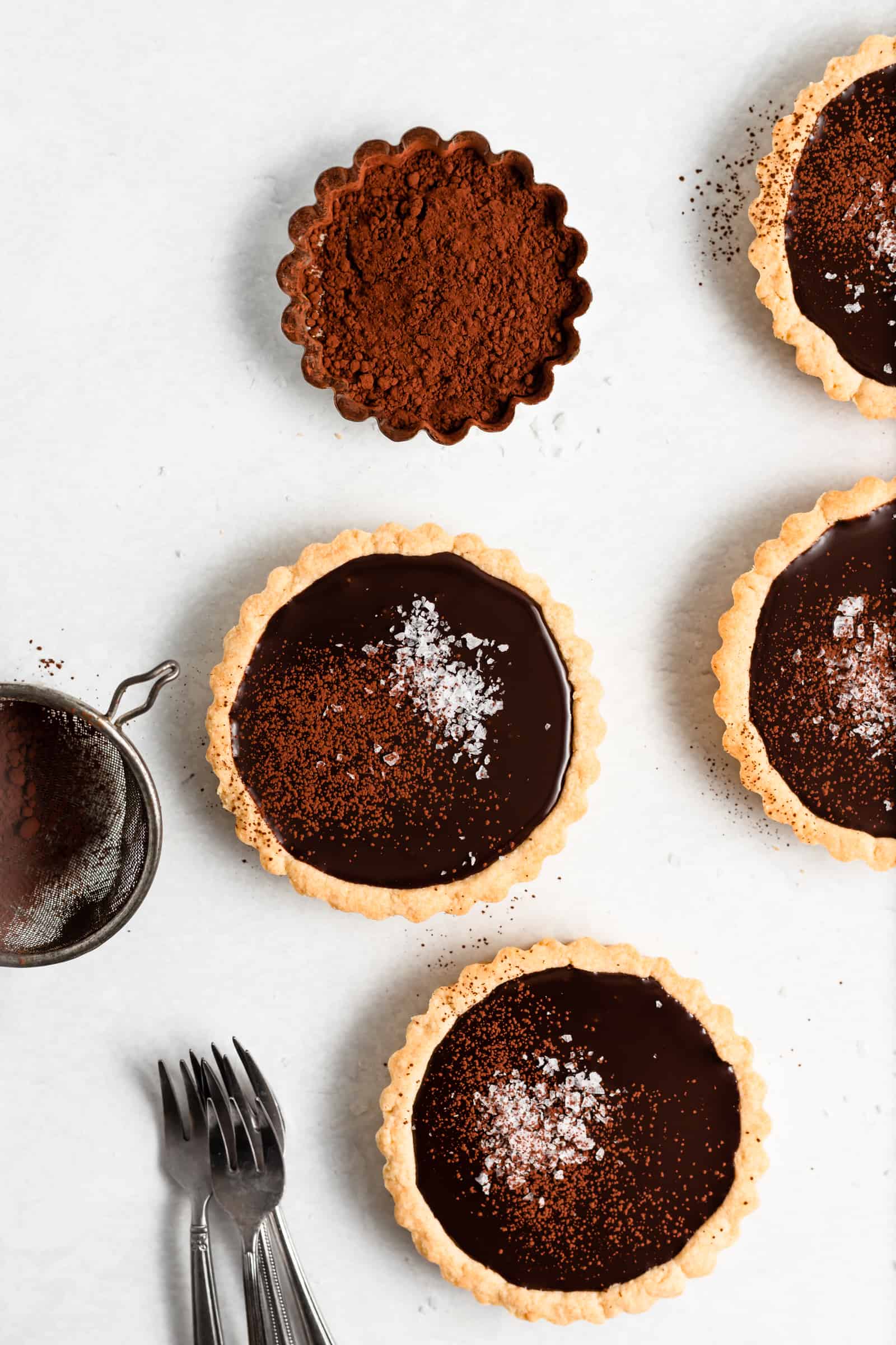 These Mini Dark Chocolate and Sea Salts Tarts have a buttery shortbread crust that’s filled with a rich and decadent truffle-like filling and topped with sea salt!