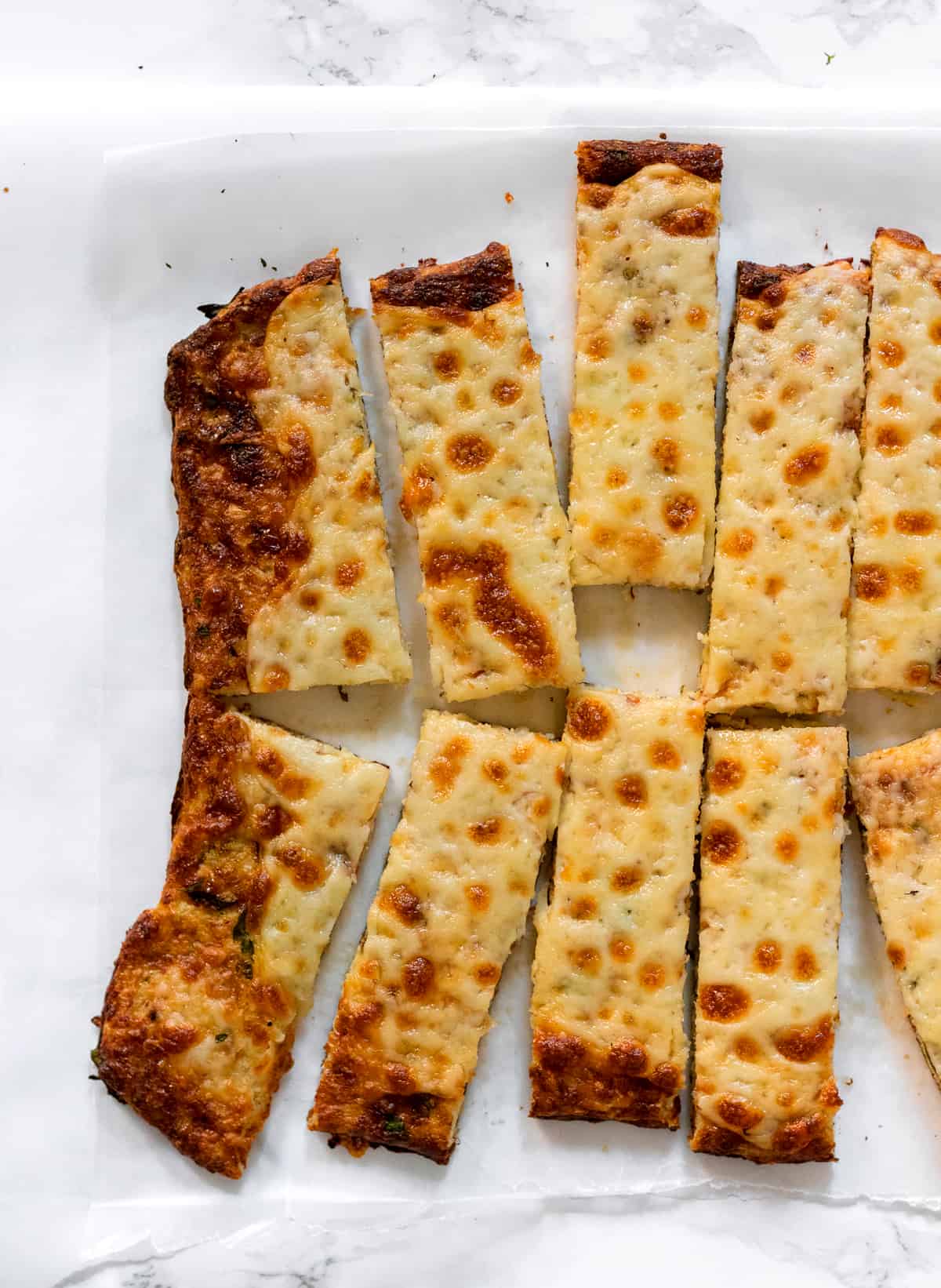 Cheesy Cauliflower Breadsticks are a gluten free and low carb alternative to traditional breadsticks. They are easy to make and packed full of flavor!