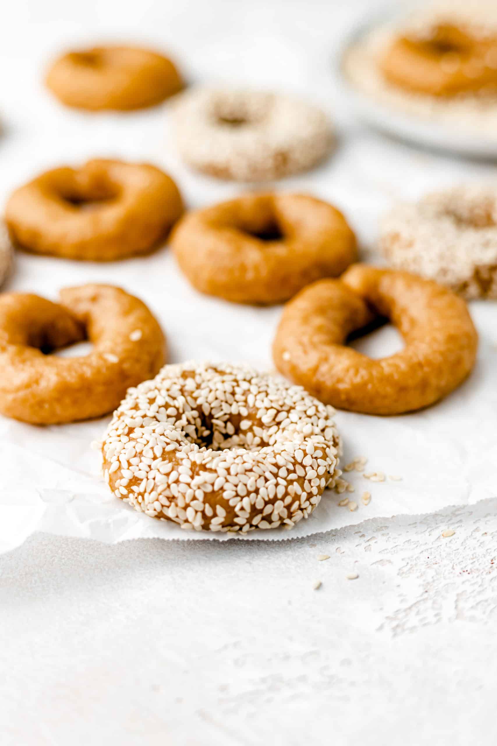 vegan greek olive oil and orange cookies with sesame seeds on parchment paper