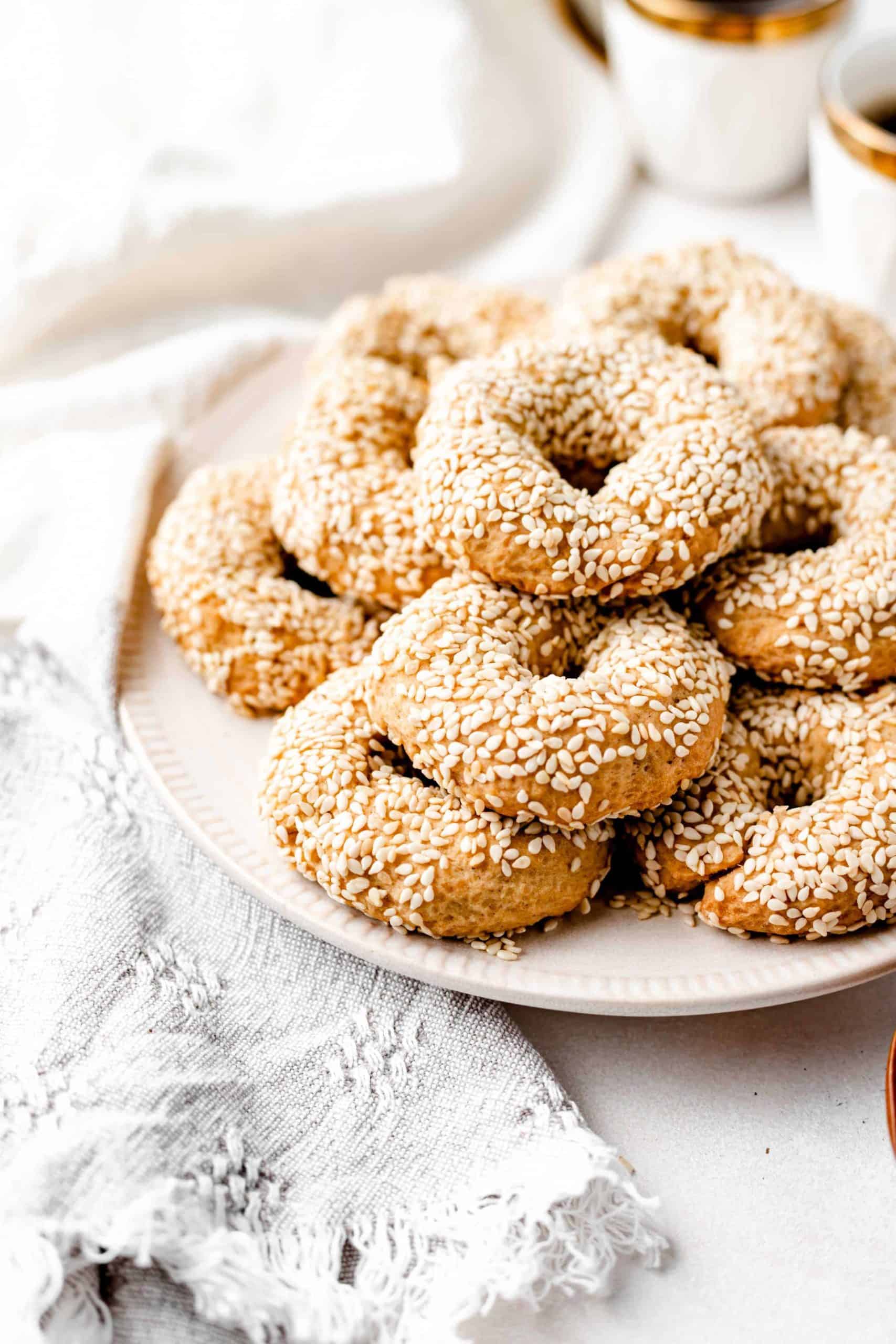 olive oil and sesame seed cookies stacked on a plate