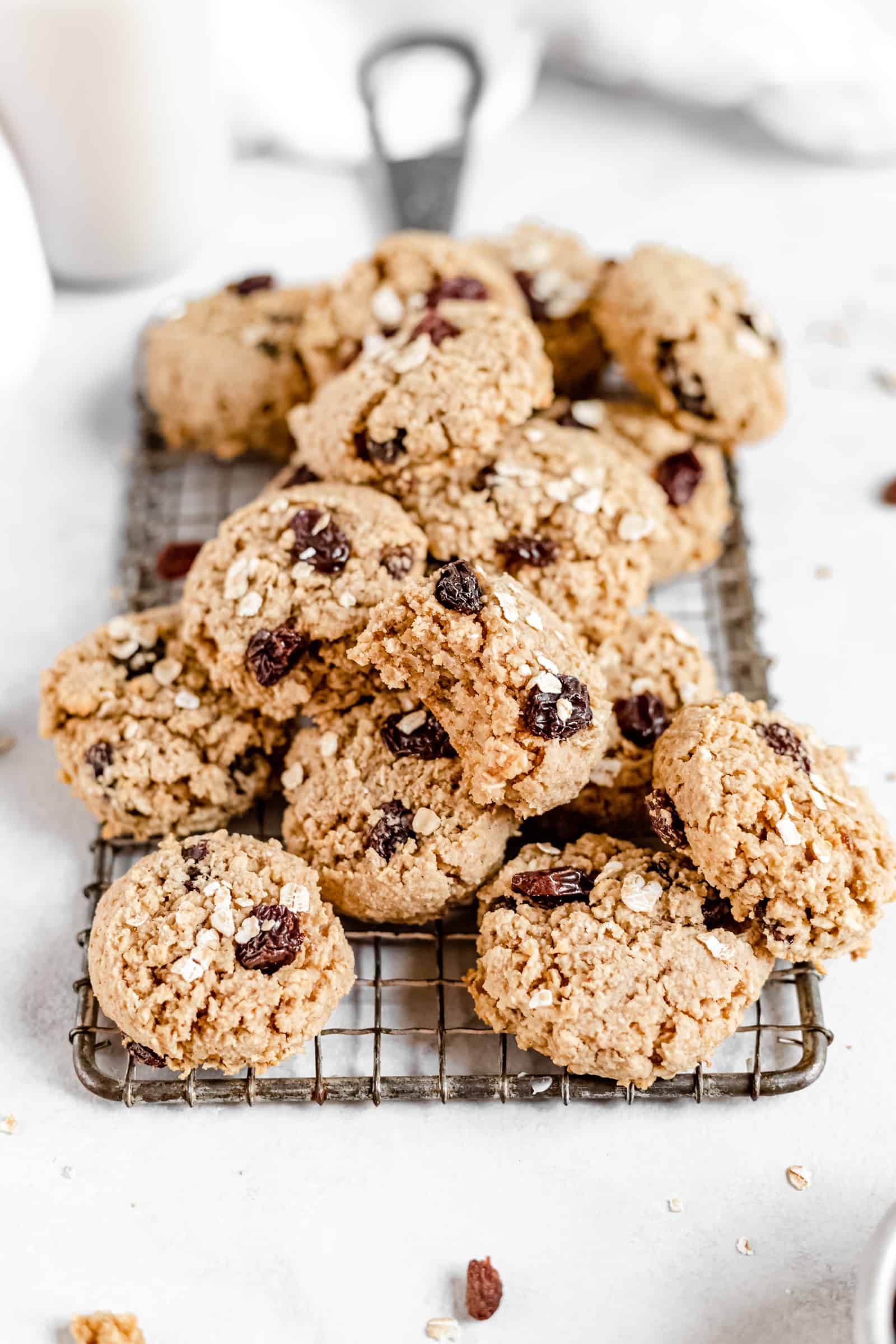 These Healthy Chewy Gluten Free Oatmeal Raisin Cookies are the best ever! They’re incredibly soft, chewy, and perfectly spiced with a hint of cinnamon. #vegan #glutenfree #oatmealraisin #cookies #healthycookies #almondflour #bakedambrosia