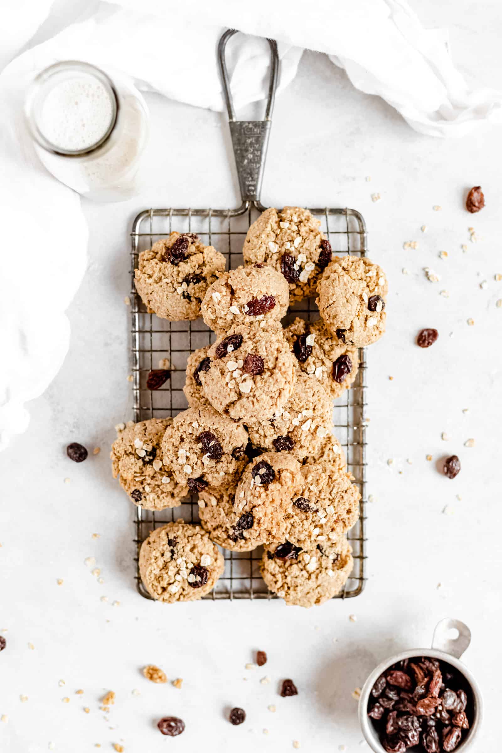 These Healthy Chewy Gluten Free Oatmeal Raisin Cookies are the best ever! They’re incredibly soft, chewy, and perfectly spiced with a hint of cinnamon. #vegan #glutenfree #oatmealraisin #cookies #healthycookies #almondflour #bakedambrosia