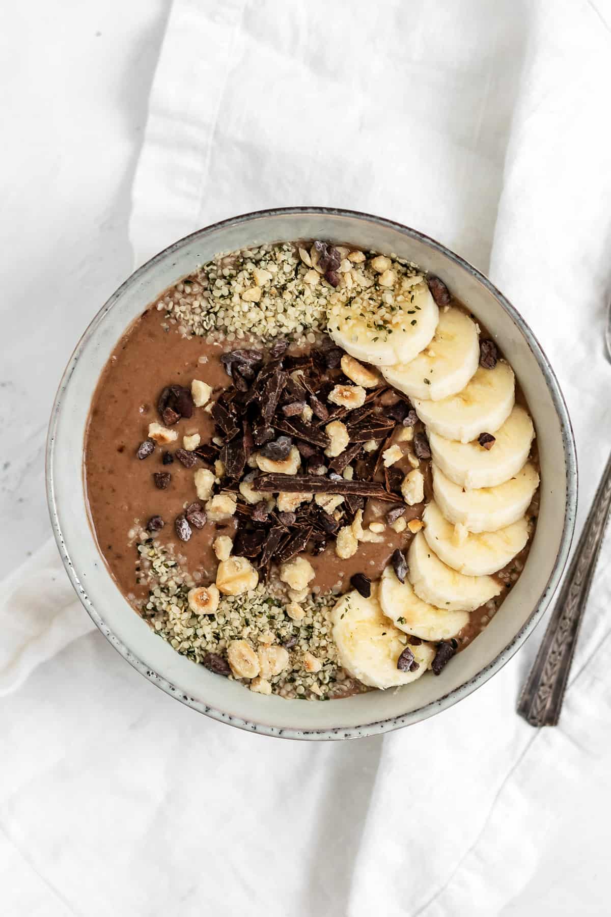 This Chocolate Hazelnut Smoothie Bowl made with cacao and roasted hazelnuts tastes just like Nutella, but healthier. Its a gluten free and vegan breakfast that comes together in just 5 minutes making it the perfect way to start the day!