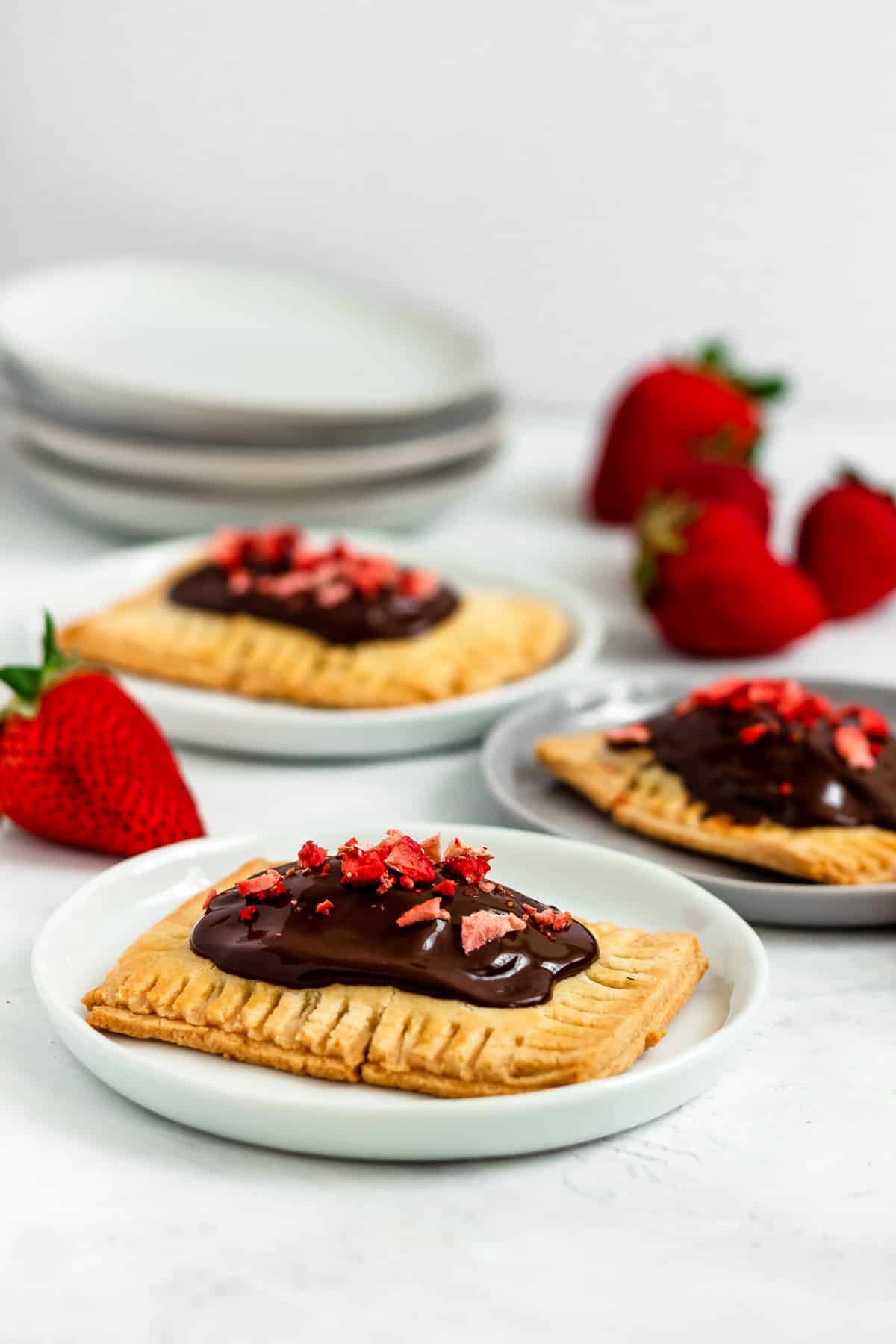 Healthy, gluten free Paleo Chocolate Covered Strawberry Pop Tarts made with a fresh strawberry filling. This healthy make-ahead breakfast, snack or dessert is easy to make, and perfect for using up your summer strawberries! (gluten free, grain free, refined sugar free)