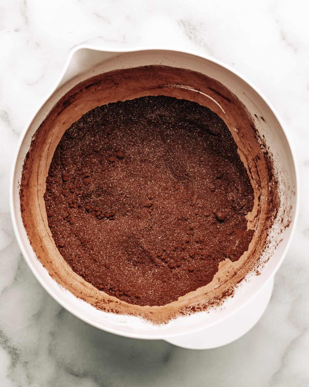cocoa powder, flour, and sugar in a mixing bowl.