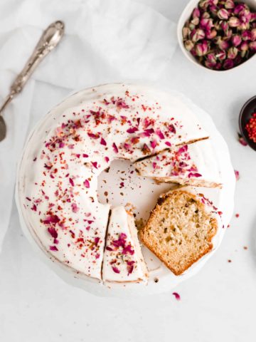 Rose and Pink Peppercorn Cake is delicious, unique, and so pretty! The cake is topped with a cream cheese glaze and finished with crushed pink peppercorns and dried rose buds.
