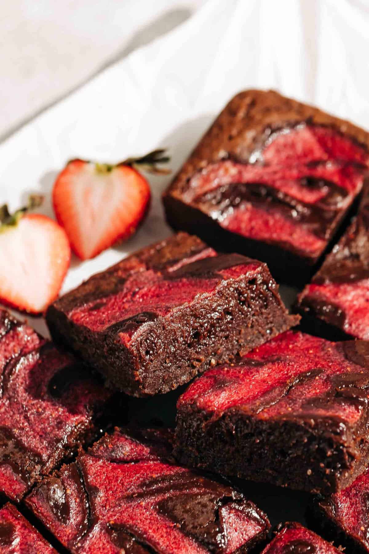 Strawberry brownies on parchment paper.