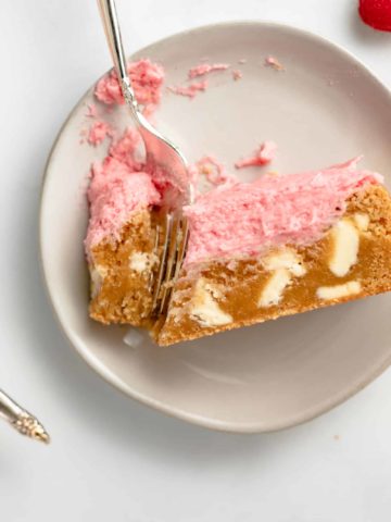 Chewy, sweet, and delicious White Chocolate Blondies are topped with a Raspberry Champagne Frosting for the ultimate dessert.