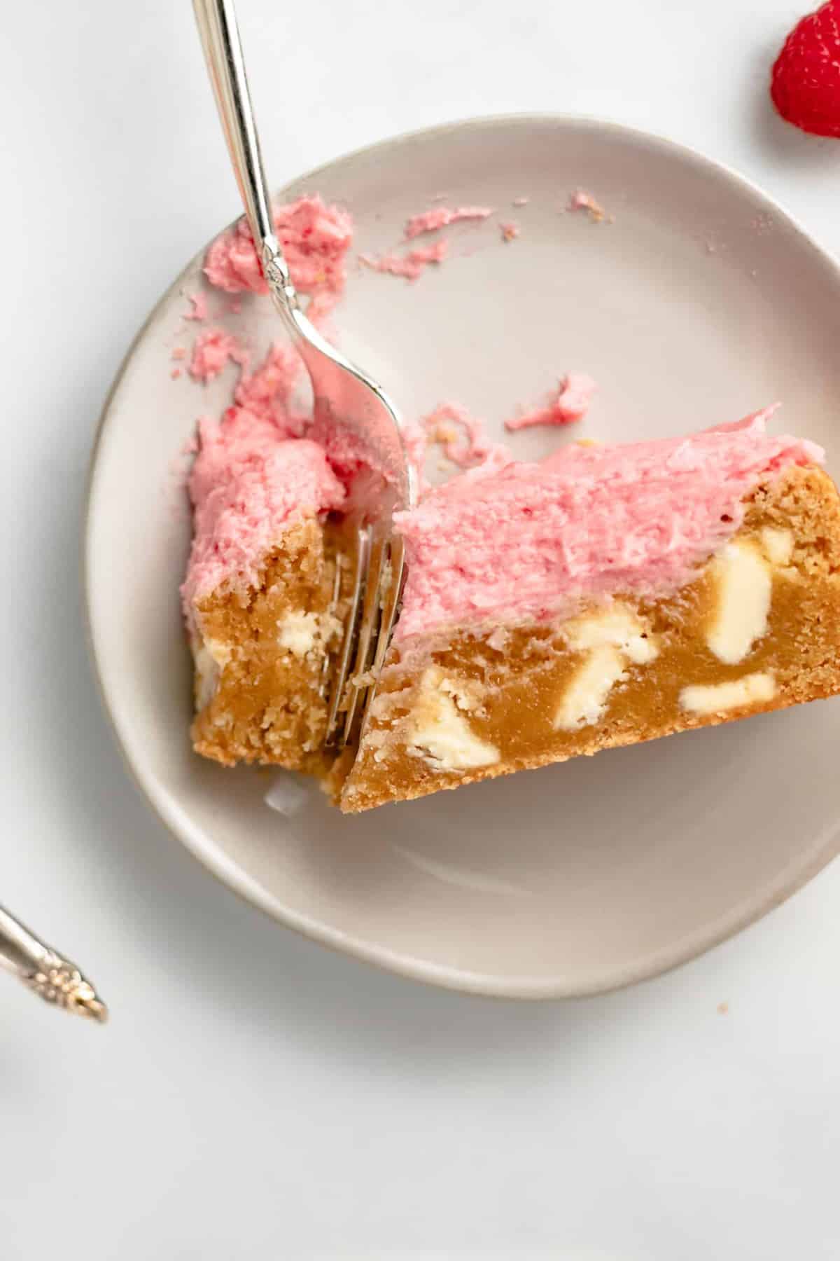 Chewy, sweet, and delicious White Chocolate Blondies are topped with a Raspberry Champagne Frosting for the ultimate dessert.