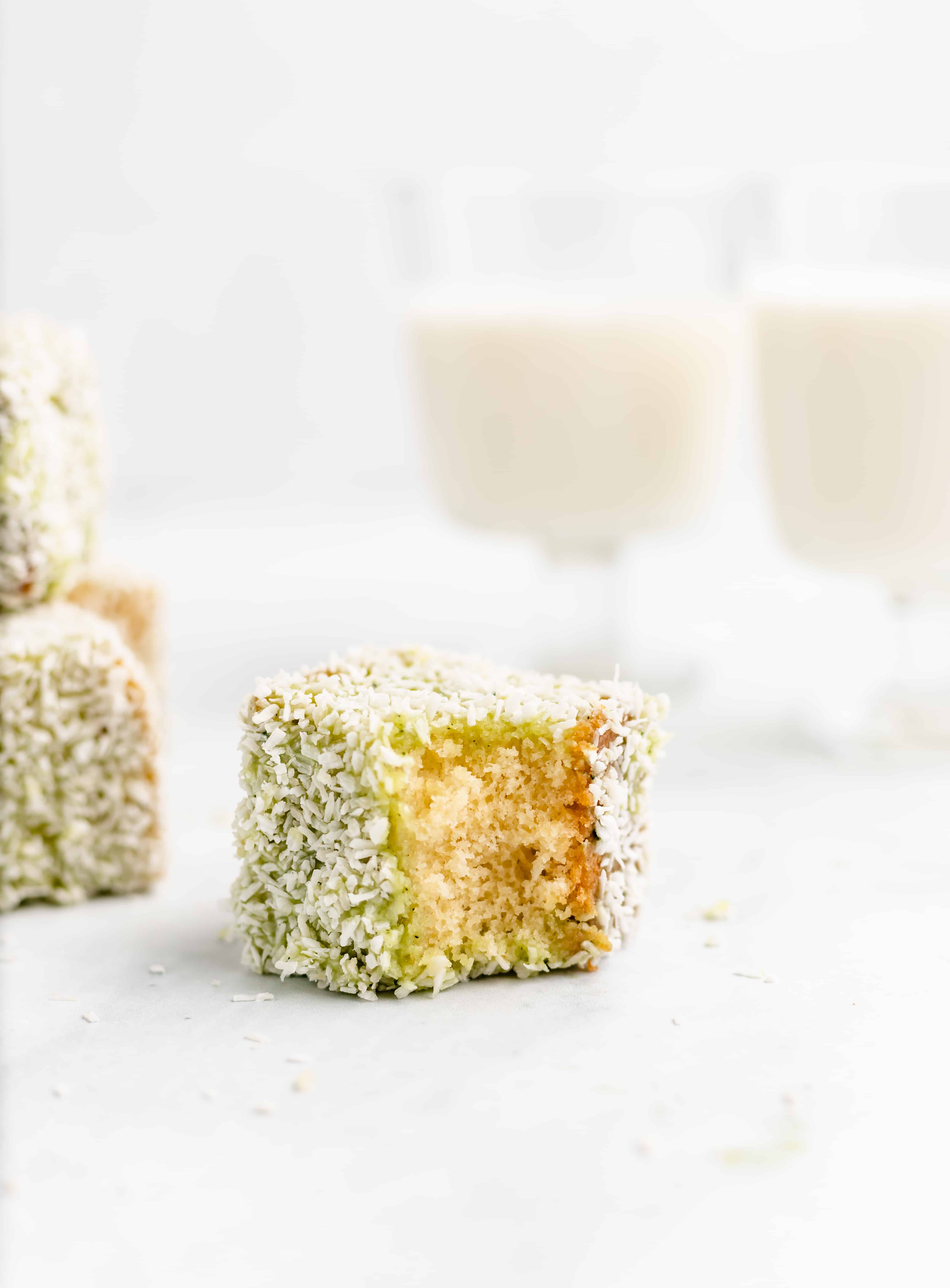 Soft and buttery sponge cake is dipped in matcha flavored white chocolate then coated in coconut. These Matcha White Chocolate Lamingtons are a perfect afternoon treat!