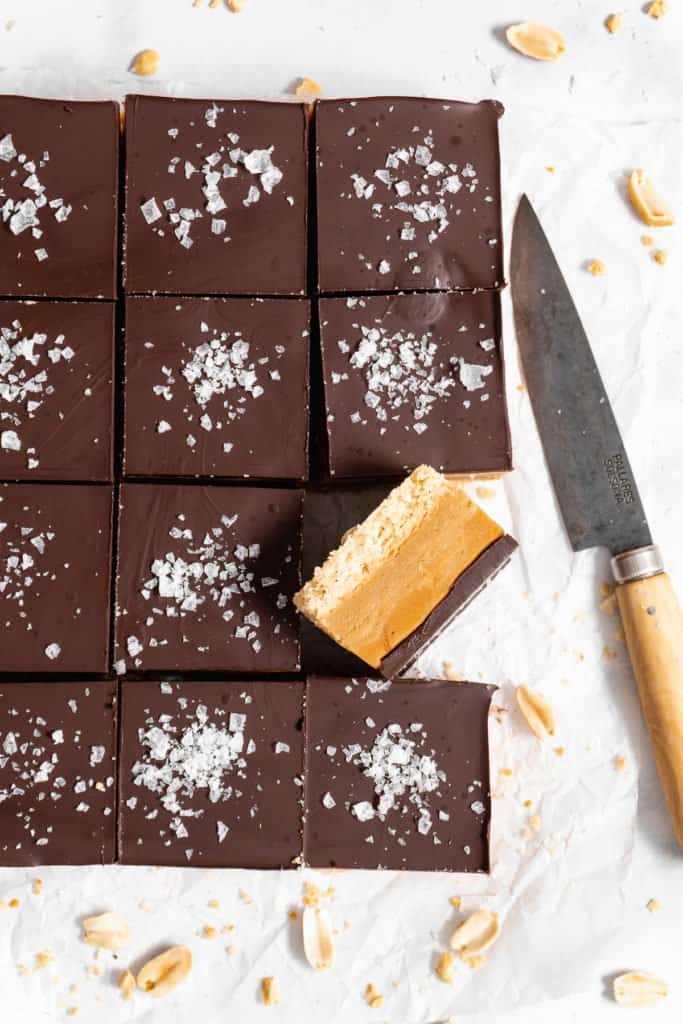 Peanut Butter Millionaire Bars on parchment paper