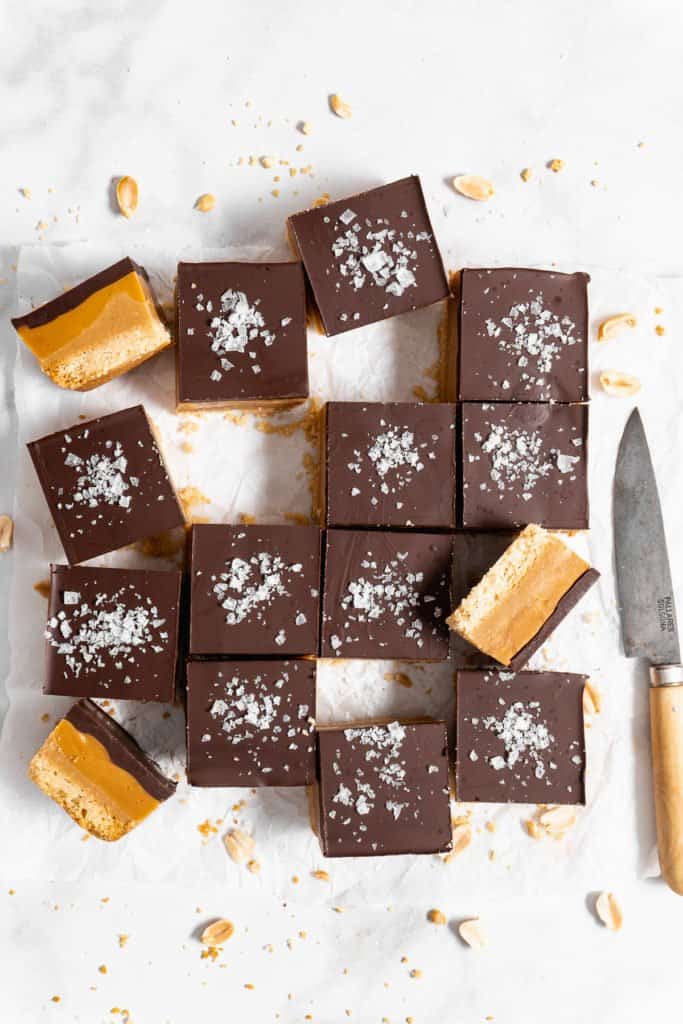 Peanut Butter Millionaire Bars on parchment paper