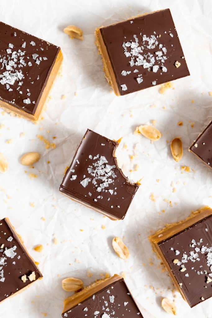 Peanut Butter Millionaire Bars on parchment paper