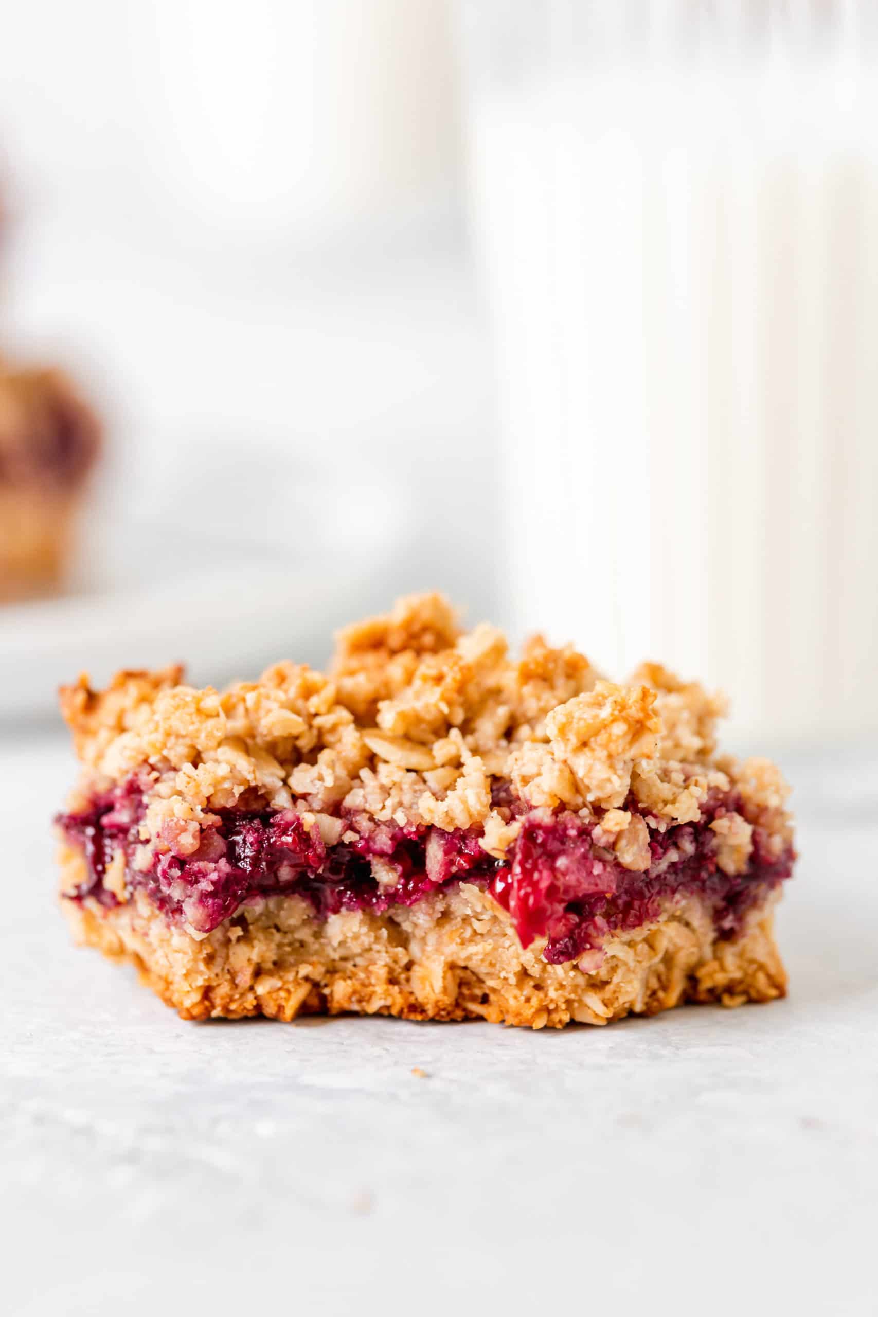 bite shot of blackberry oat crumb bar