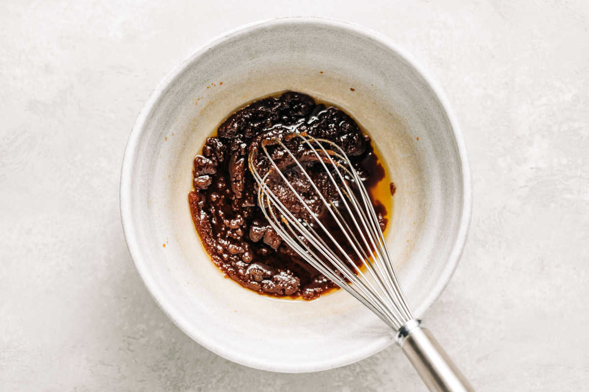 Melted butter, brown sugar, and sugar in a mixing bowl.