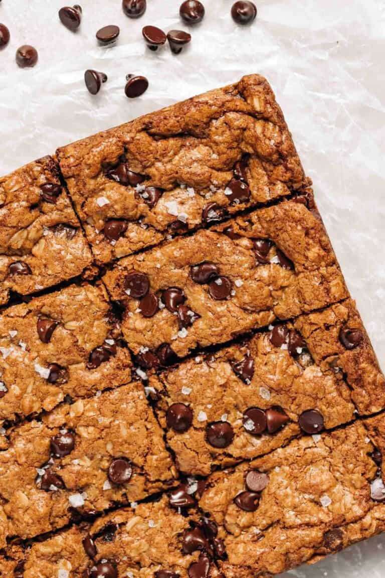 Oatmeal chocolate chip cookie bars on wax paper.