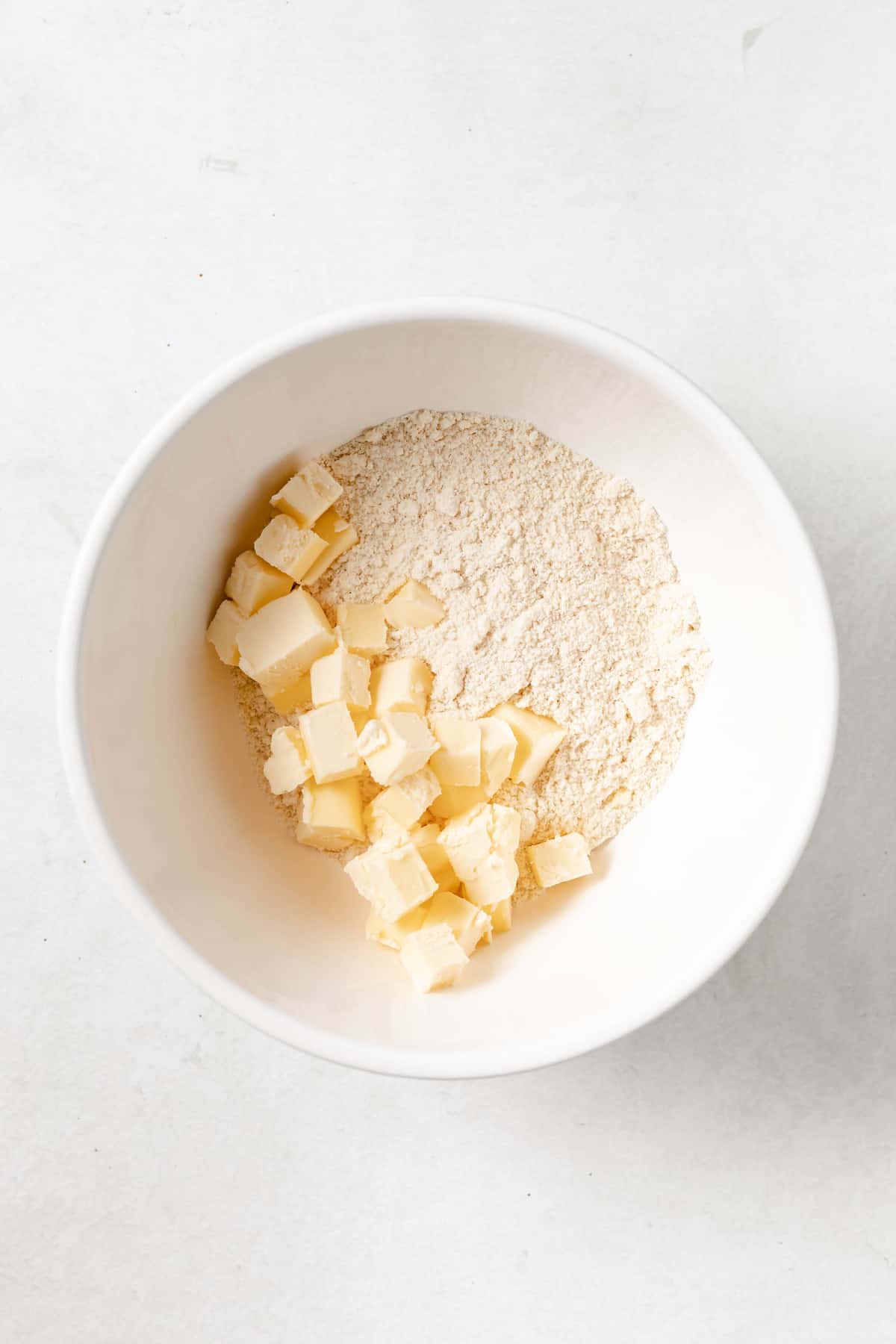 almond flour, coconut flour, tapioca flour and butter in a mixing bowl.