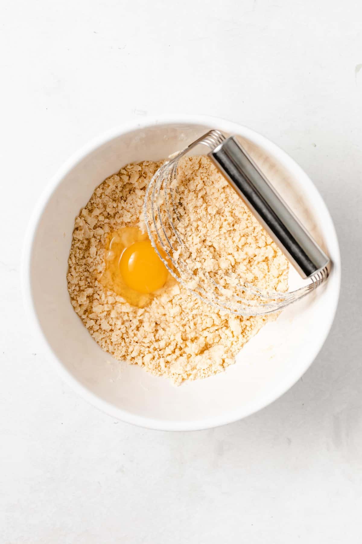 paleo flour with egg in a mixing bowl.