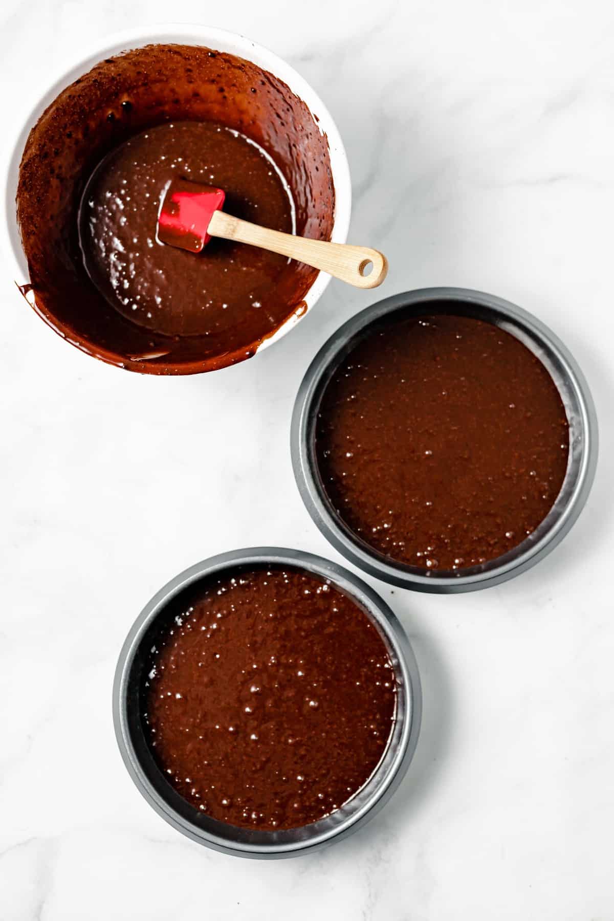 chocolate cake batter in pans