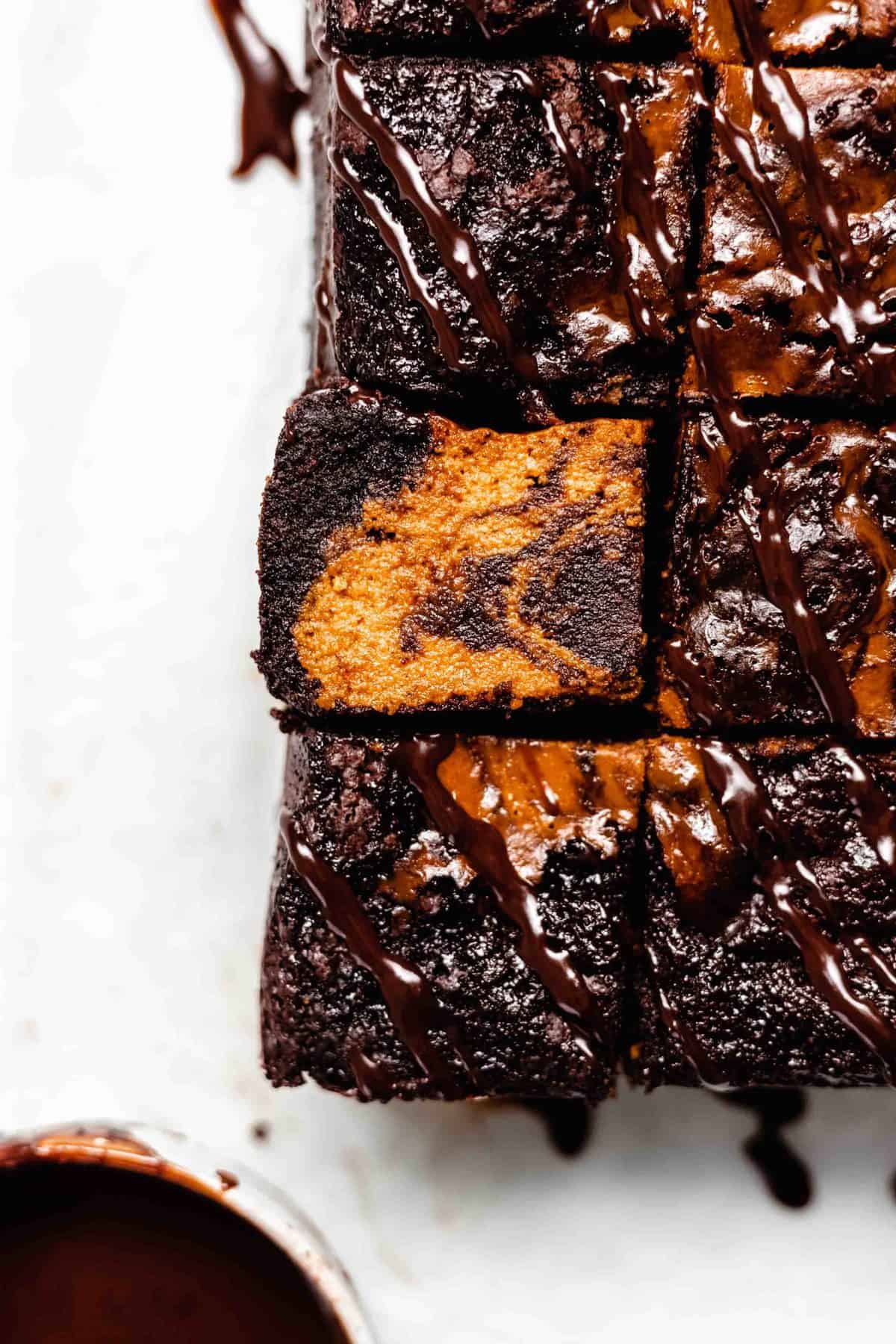 pumpkin swirl brownies drizzled with ganache. 