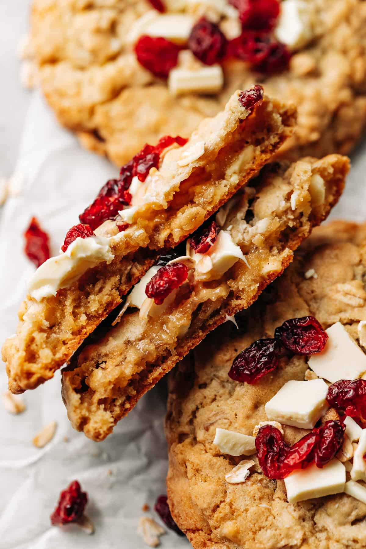 cranberry and white chocolate chip oatmeal cookie cut in half.