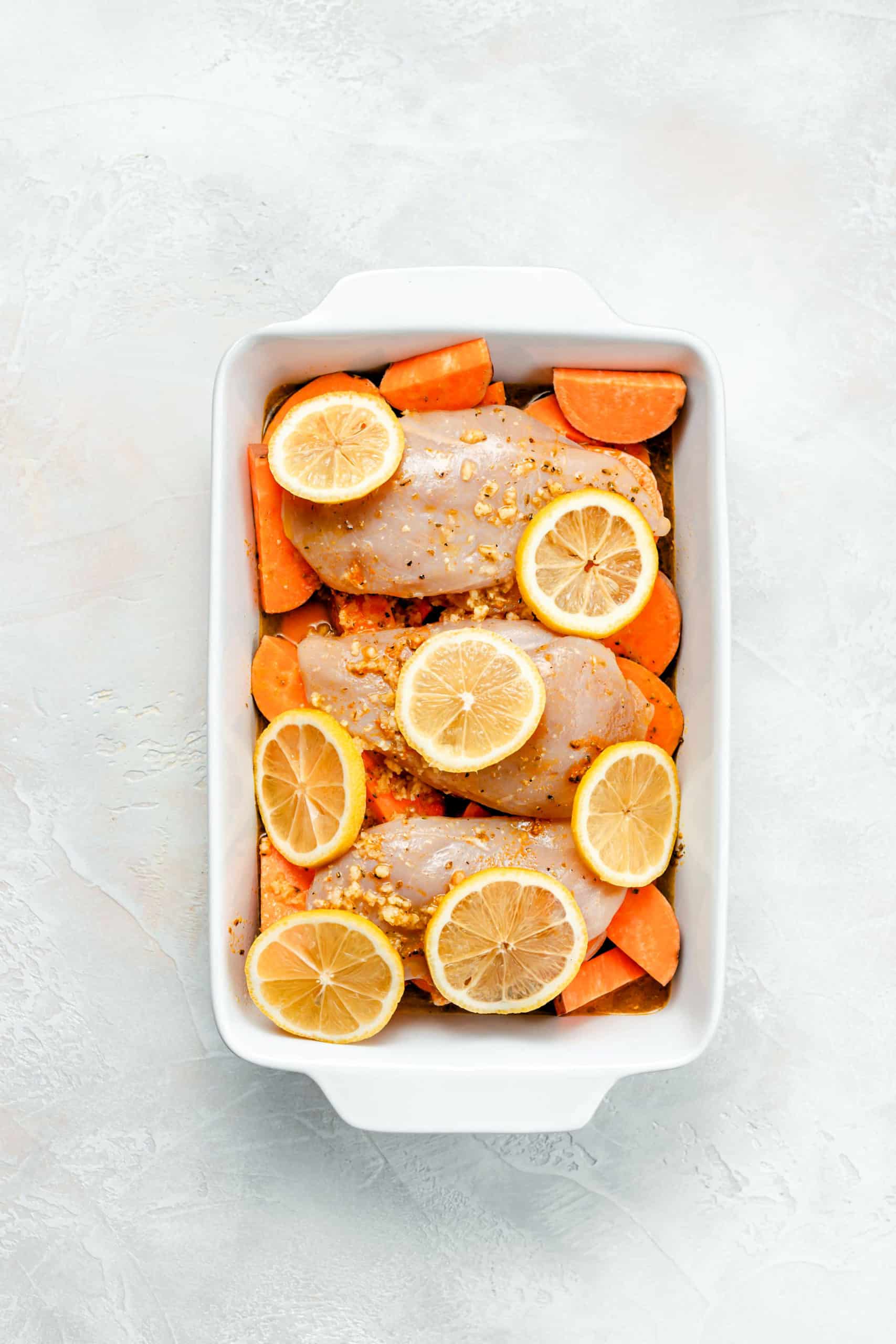 sweet potatoes and chicken in roasting pan