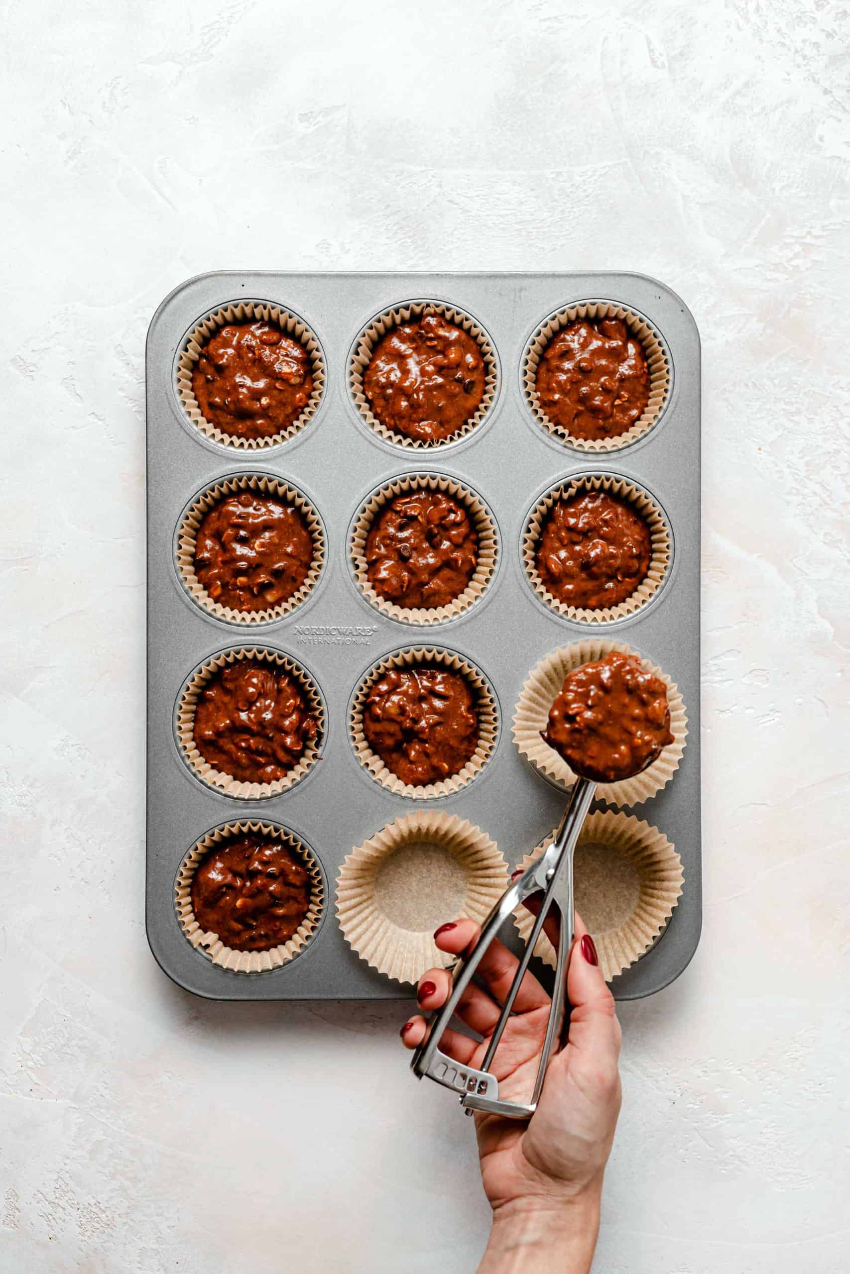 Gluten Free Chocolate Peanut Butter Banana Muffin batter in muffin pan