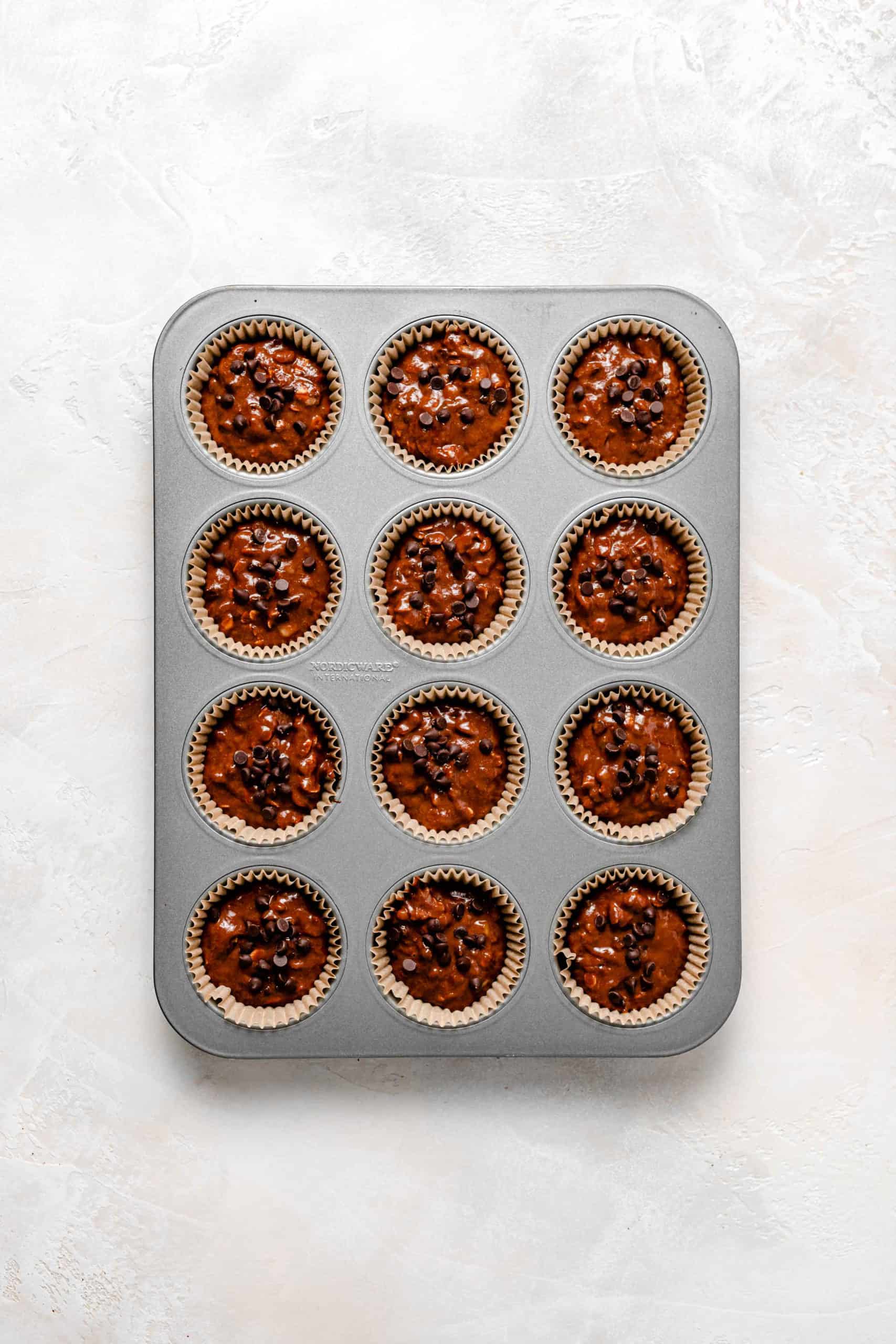 Gluten Free Chocolate Peanut Butter Banana Muffin batter in muffin pan