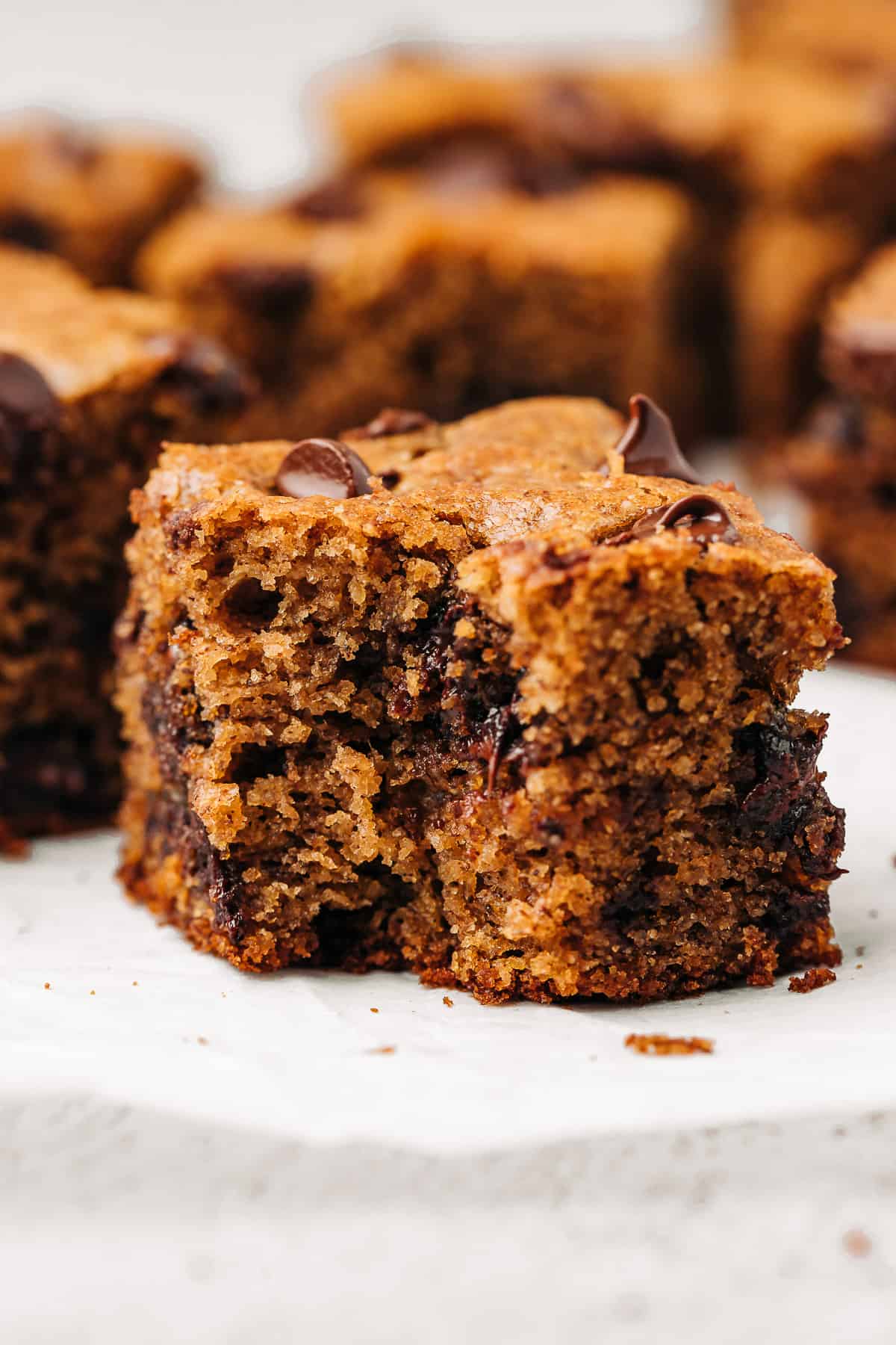 Bite taken out of a paleo chocolate chip banana bread square.