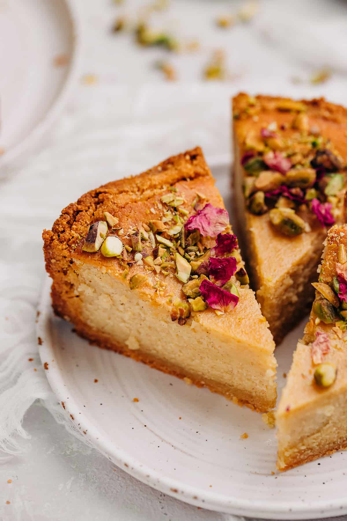 three slices of persian love cake on a white plate.