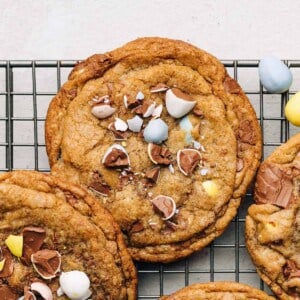 Cadbury Mini Egg chocolate chip cookies on a wire rack.