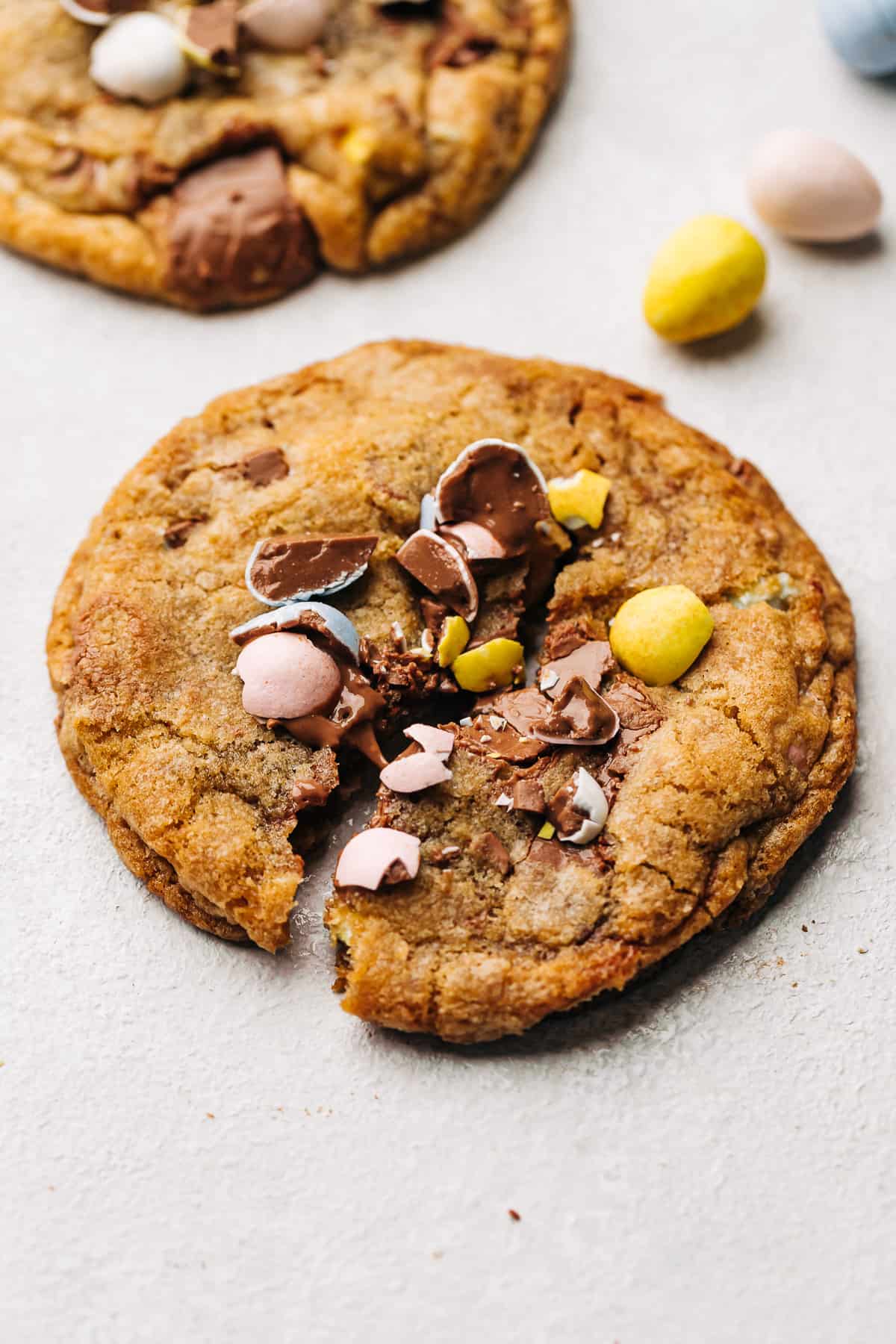 Cadbury Mini Egg milk chocolate chip cookie cut in the center.