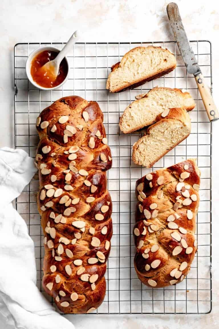 two loaves of tsoureki on a cooling rack.