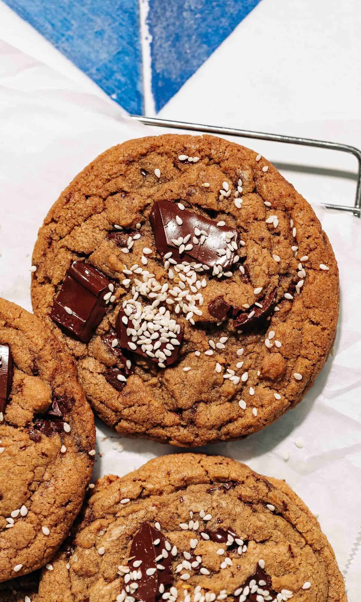 chocolate chip tahini cookies on a wire rack.