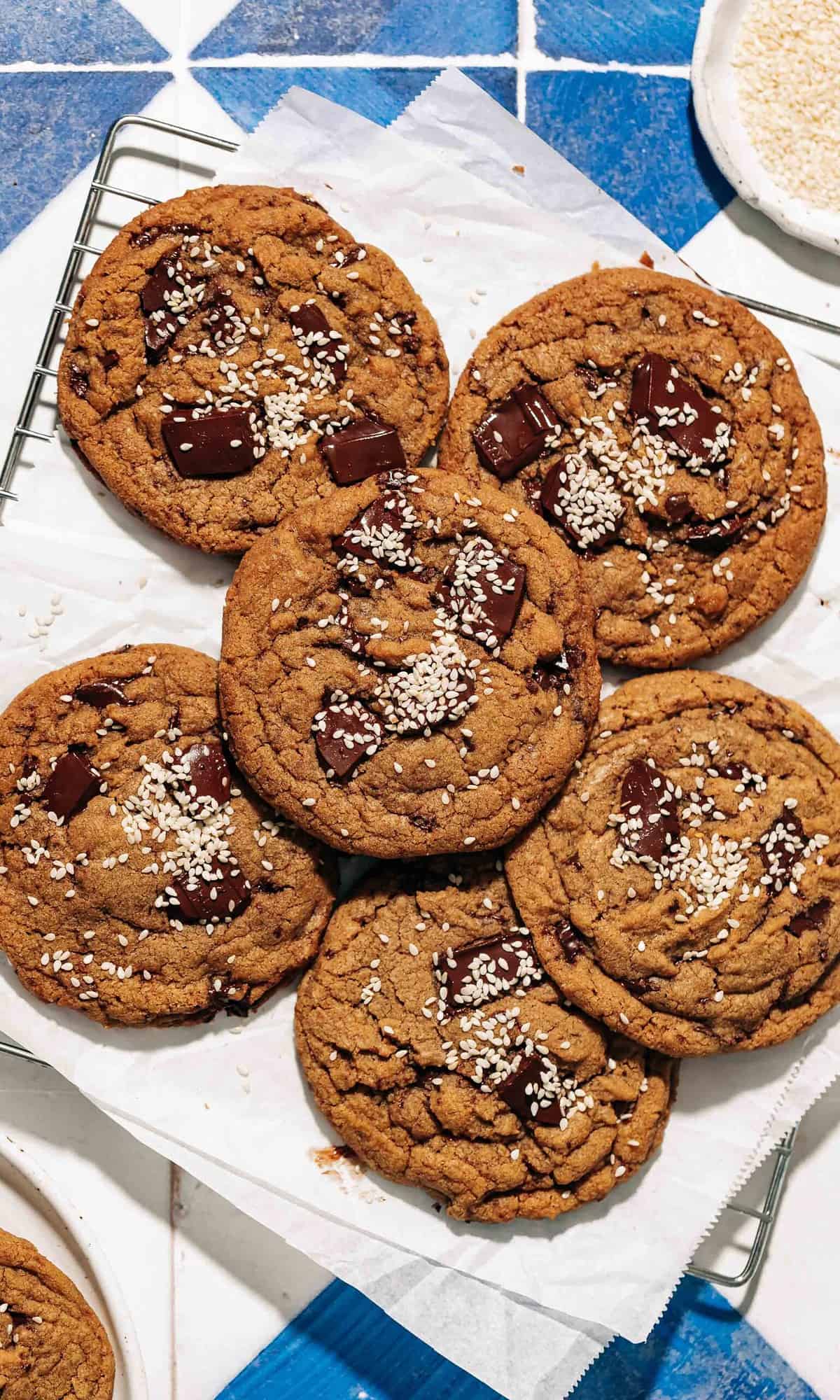 chocolate chip tahini cookies on a wire rack.