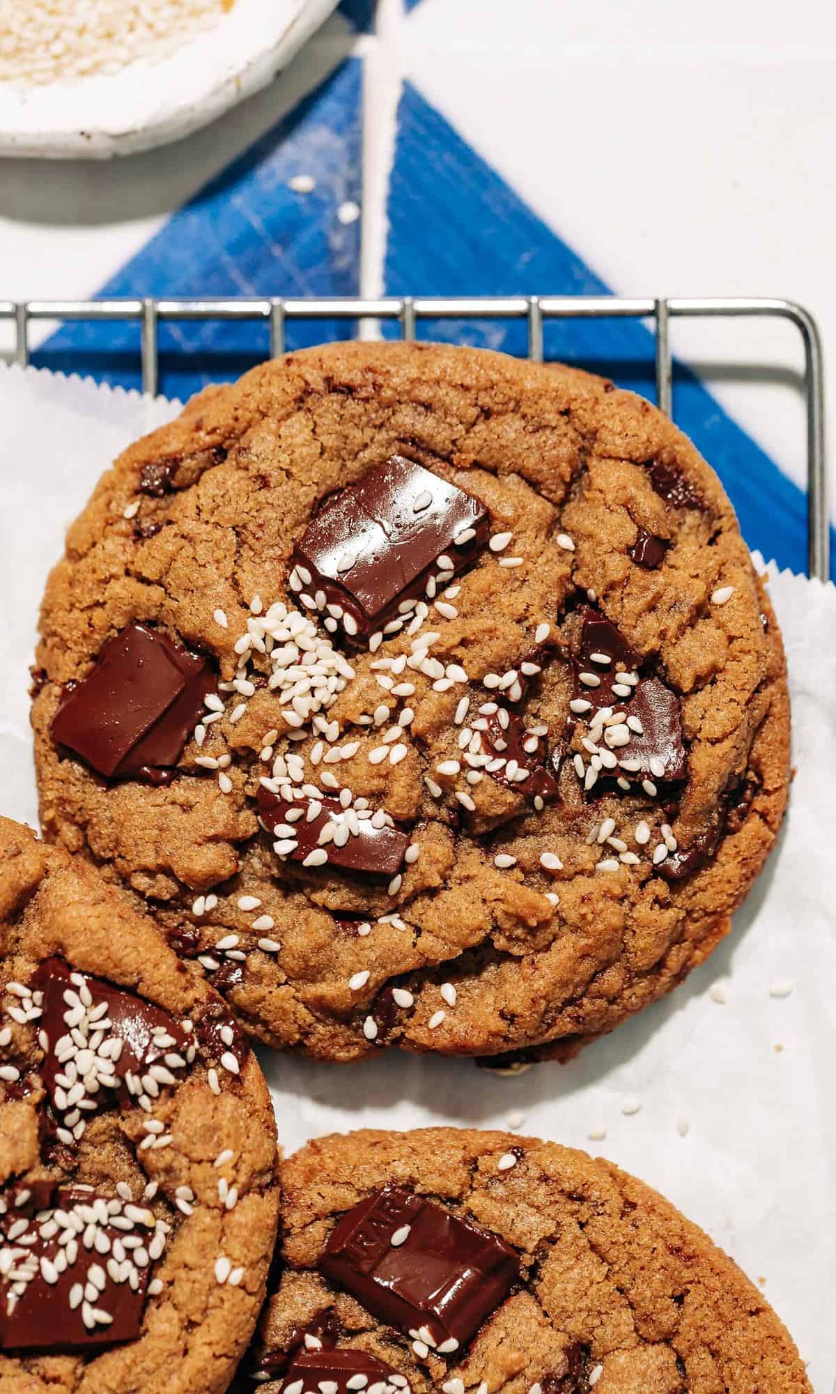 chocolate chunk tahini cookies on a wire rack.