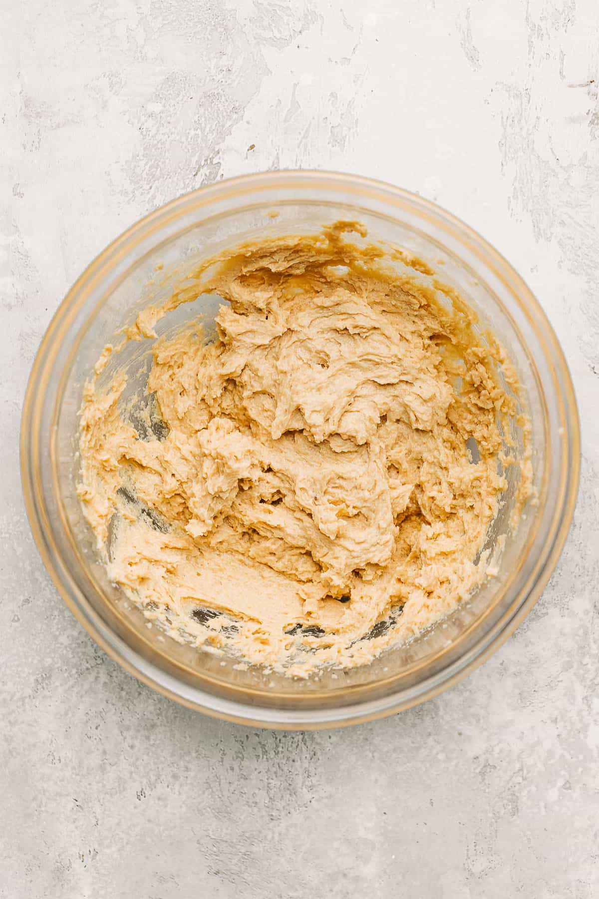 Creamed butter, sugar, eggs and vanilla extract in a mixing bowl.