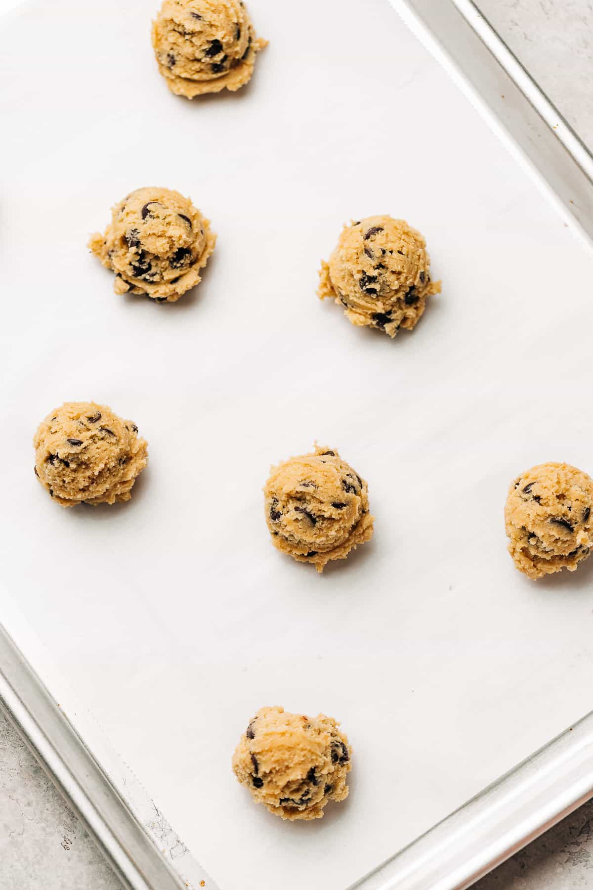 chocolate chip cookie dough on a baking sheet.